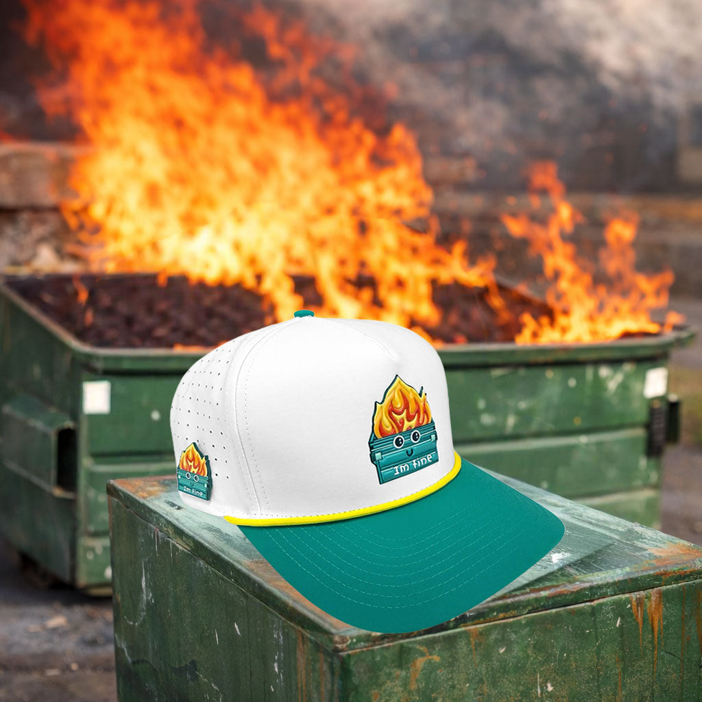 Logie Joe's Golf Dumpster Fire snapback hat with built-in magnetic ball marker holder, adjustable strap, white and teal design.