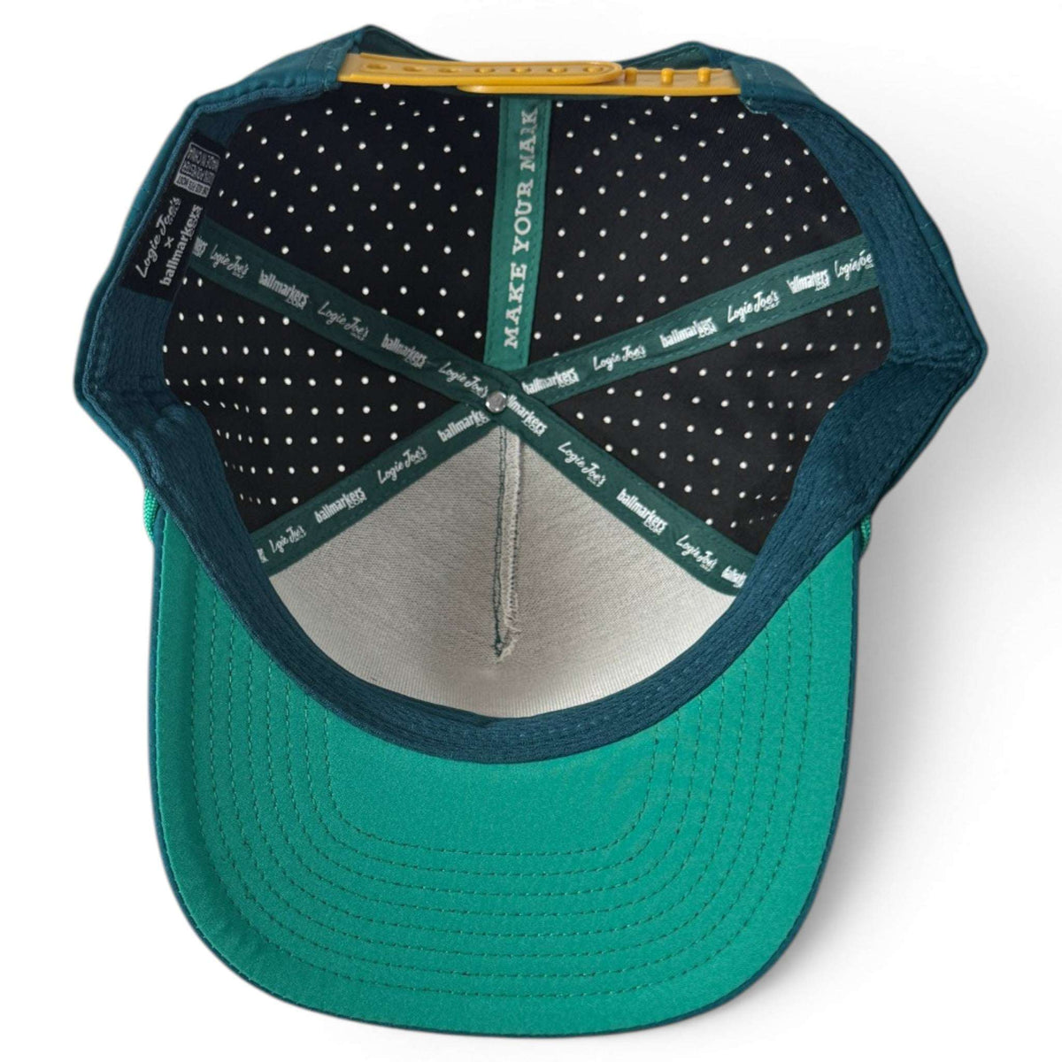 Logie Joe's Golf Driftwood snapback hat with magnetic ball marker holder, adjustable strap, teal wood boat design, and included marker.