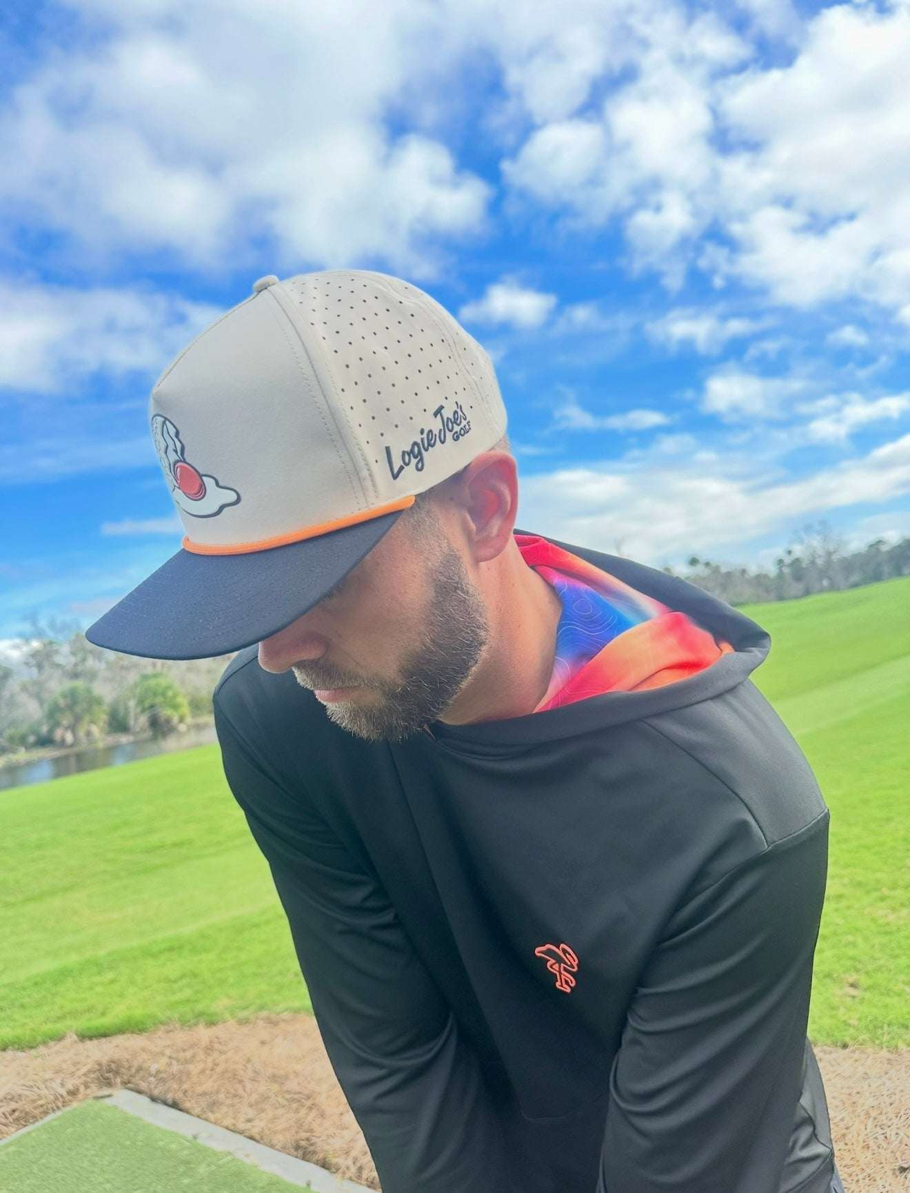 Logie Joe's Golf Breakfast Ball snapback hat with magnetic ball marker holder, adjustable strap, in tan color.
