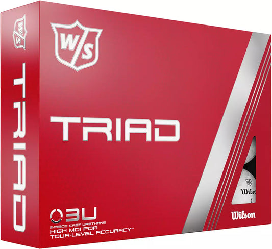 Wilson 2022 Triad golf balls with white exterior, shown in a close-up image on a golf course.